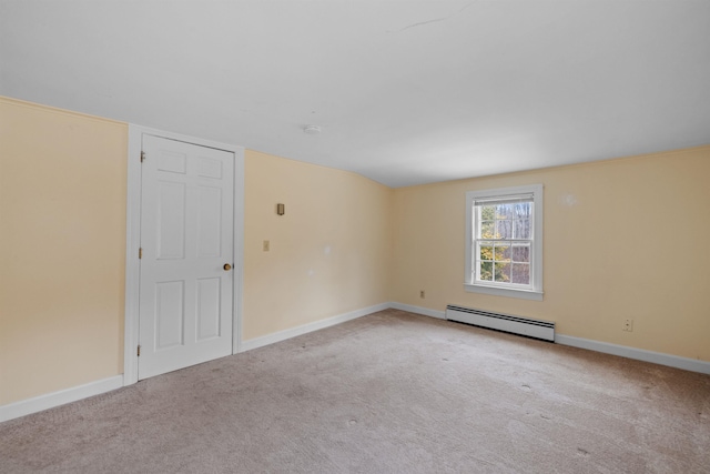 spare room with a baseboard radiator and light carpet