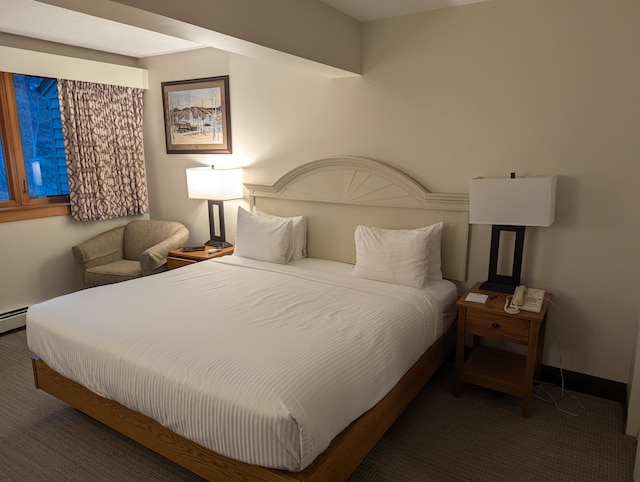 bedroom featuring dark colored carpet and a baseboard radiator