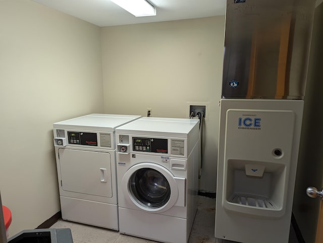 clothes washing area featuring separate washer and dryer