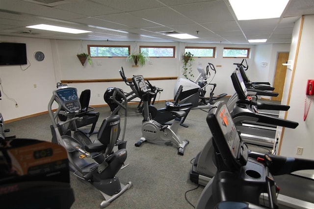 gym with a healthy amount of sunlight and a paneled ceiling