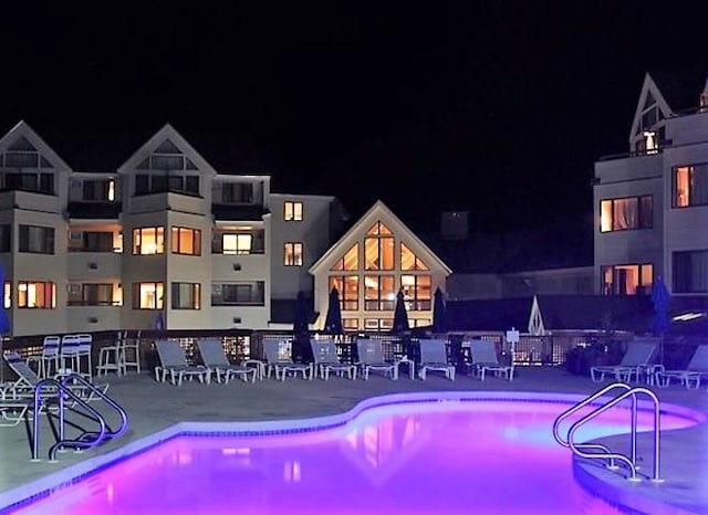 view of pool at twilight