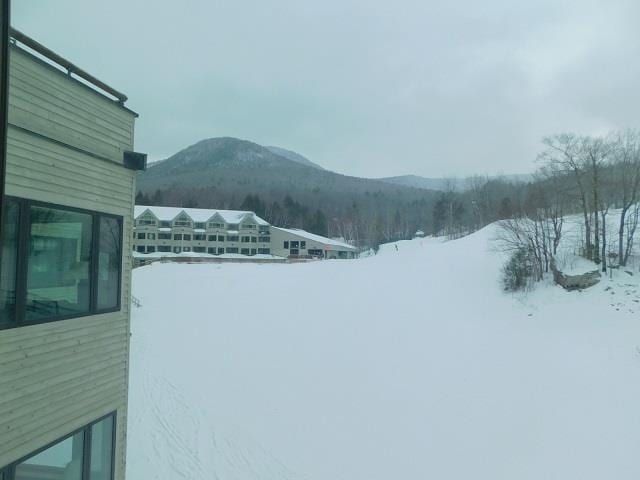 view of snow covered exterior with a mountain view