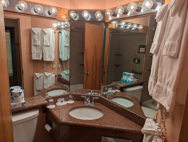 bathroom featuring vanity, toilet, and a tile shower