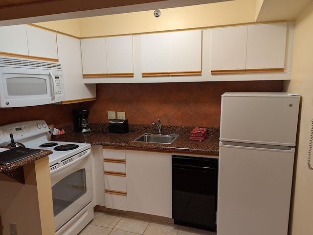 kitchen with white cabinets, white appliances, sink, and light tile patterned flooring