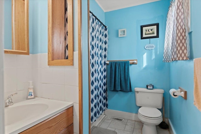 bathroom featuring tile patterned floors, toilet, a shower with curtain, ornamental molding, and vanity