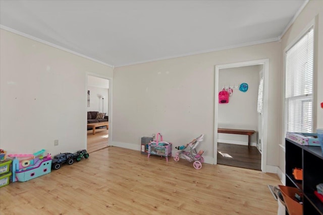 game room featuring light hardwood / wood-style floors and ornamental molding