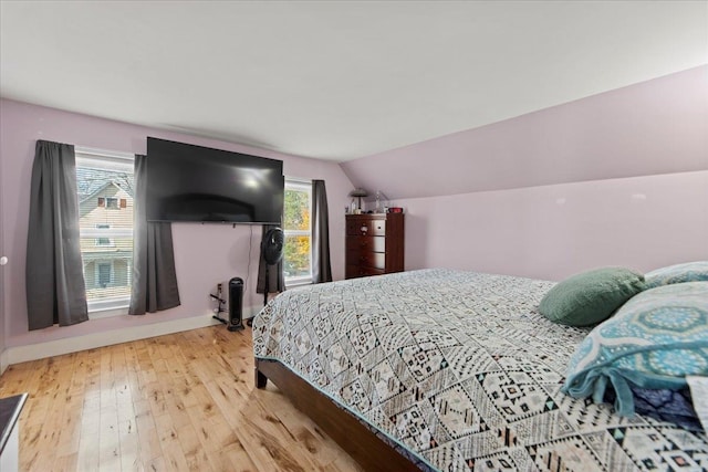 bedroom featuring vaulted ceiling and hardwood / wood-style flooring