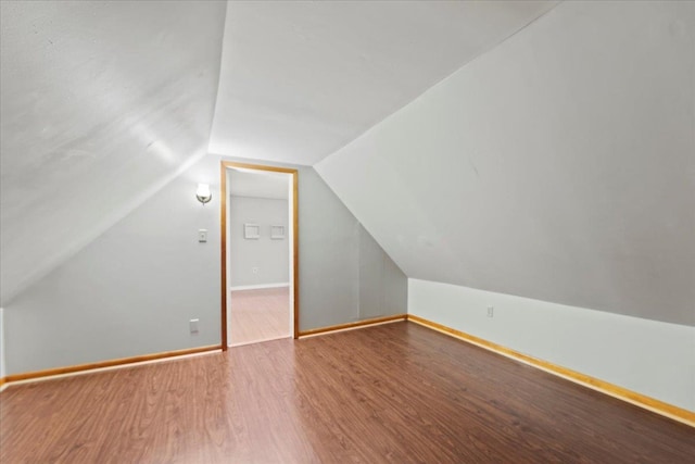 bonus room with vaulted ceiling and hardwood / wood-style flooring