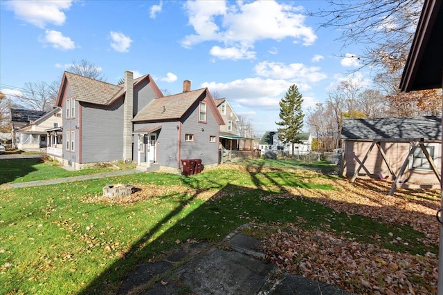 exterior space featuring a shed and a lawn