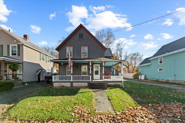 view of front of property featuring a porch and a front lawn