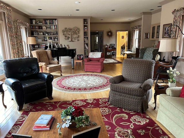 living room with ornamental molding, hardwood / wood-style floors, and plenty of natural light