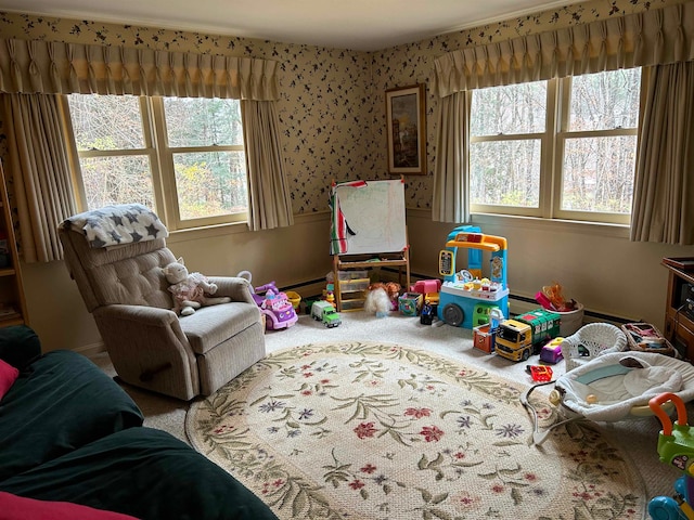 game room featuring baseboard heating, carpet floors, and plenty of natural light