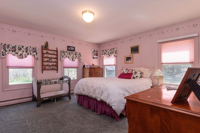 carpeted bedroom featuring a baseboard heating unit