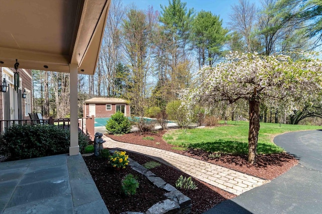 exterior space with a fenced in pool and an outbuilding