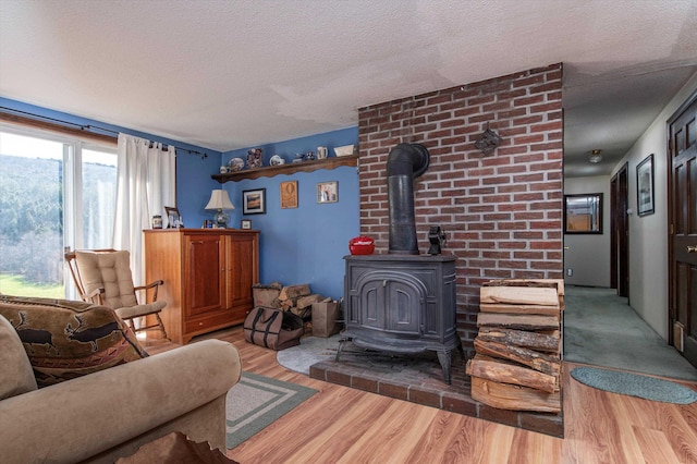 1319 Brandon Mountain Rd, Rochester, VT 05767 - living room featuring a wood stove, a textured ceiling, and wood finished floors