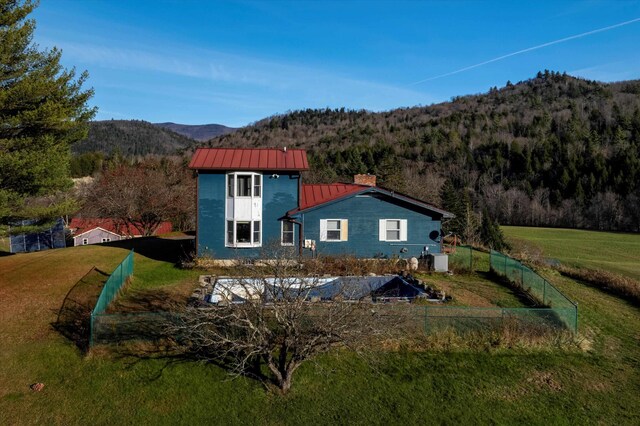 1319 Brandon Mountain Rd, Rochester, VT 05767 - back of property with a standing seam roof, a mountain view, a chimney, metal roof, and a forest view
