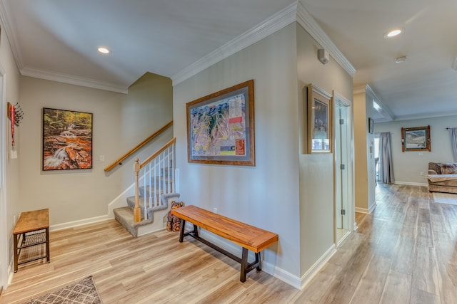 hallway featuring light wood-type flooring and ornamental molding