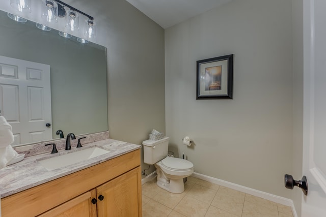 bathroom with tile patterned flooring, vanity, and toilet