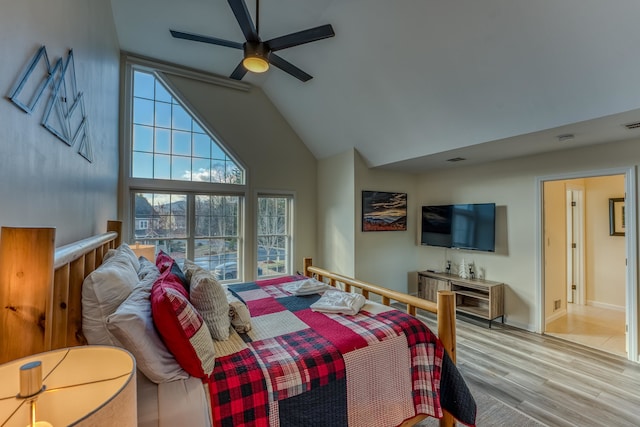 bedroom featuring ceiling fan, light wood-type flooring, and high vaulted ceiling