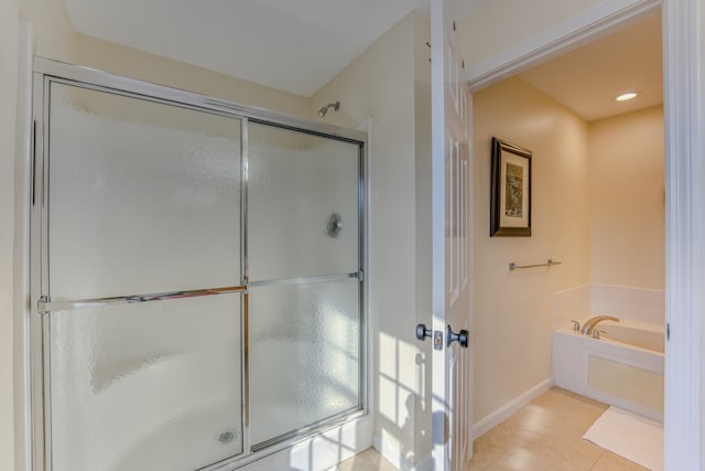 bathroom with separate shower and tub and tile patterned floors