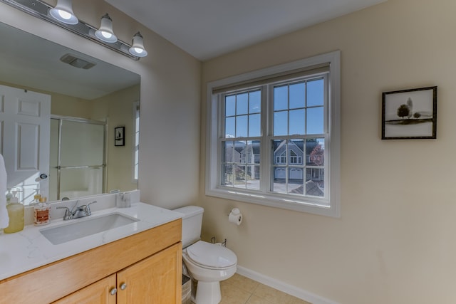 bathroom featuring tile patterned flooring, vanity, toilet, and an enclosed shower