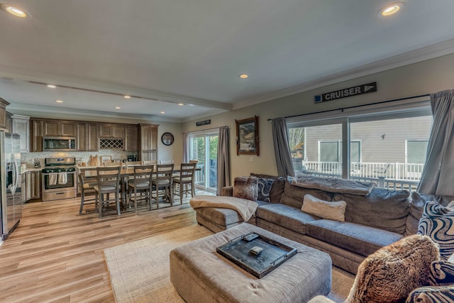 living room with light hardwood / wood-style floors and crown molding