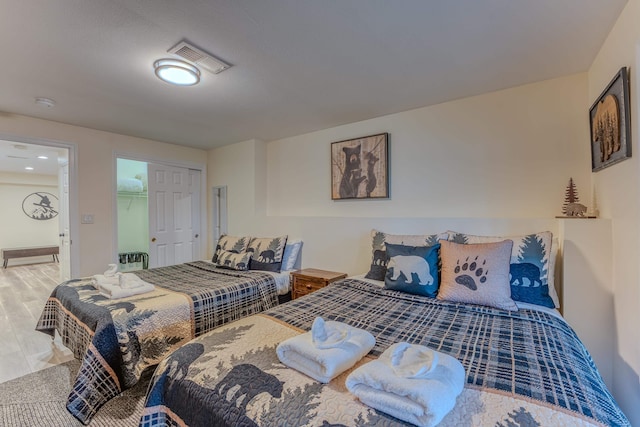 bedroom with a walk in closet and a closet