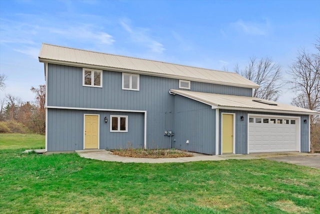 view of property featuring a front yard and a garage