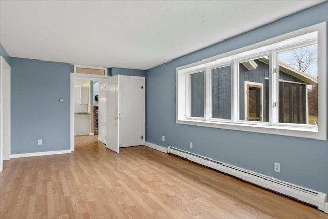 unfurnished bedroom featuring a baseboard radiator and light hardwood / wood-style flooring