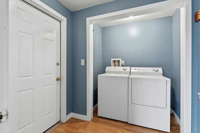 laundry area featuring washer and dryer and light wood-type flooring