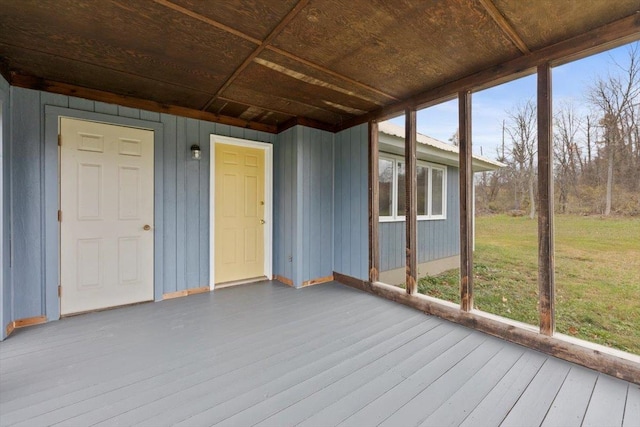 unfurnished sunroom featuring plenty of natural light and wood ceiling