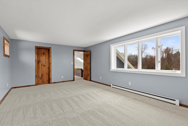 carpeted spare room with baseboard heating