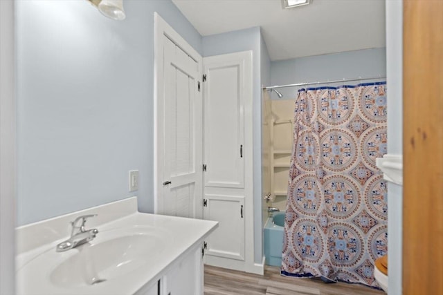 bathroom with vanity, wood-type flooring, and shower / tub combo