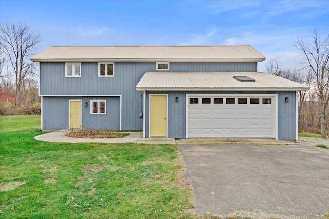 front facade with a garage and a front yard