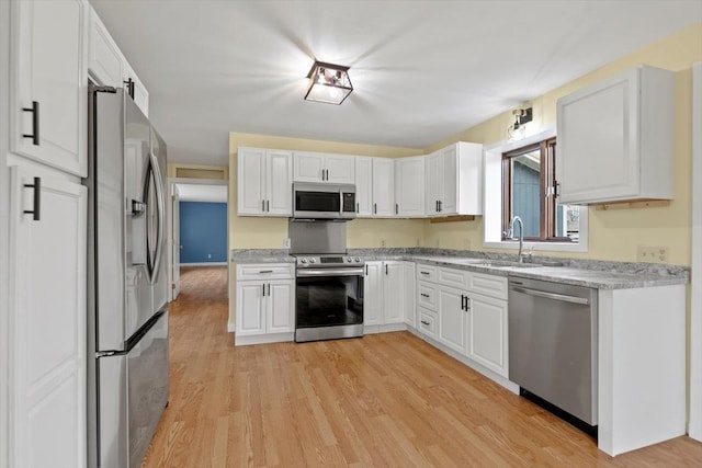 kitchen featuring white cabinets, sink, and appliances with stainless steel finishes