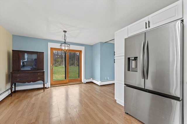 kitchen featuring baseboard heating, stainless steel fridge with ice dispenser, light hardwood / wood-style flooring, decorative light fixtures, and white cabinets