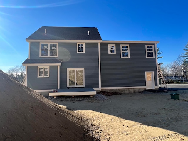 back of property with a wooden deck