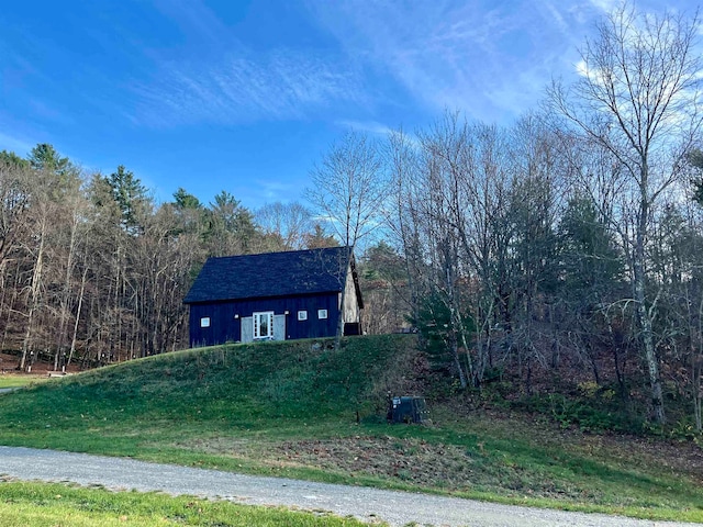 view of side of home with a lawn