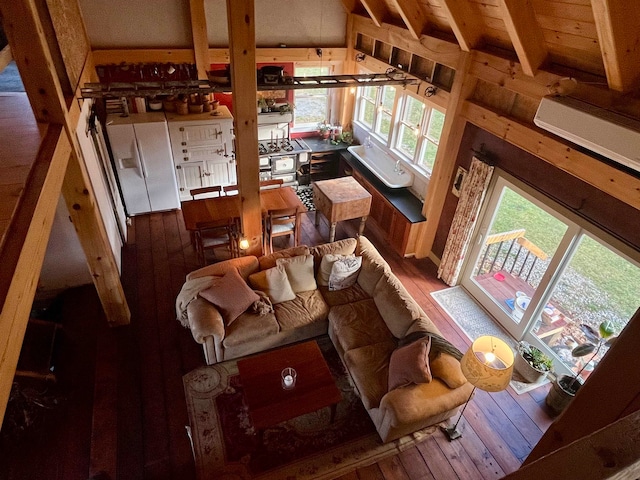 living room with hardwood / wood-style floors and lofted ceiling with beams