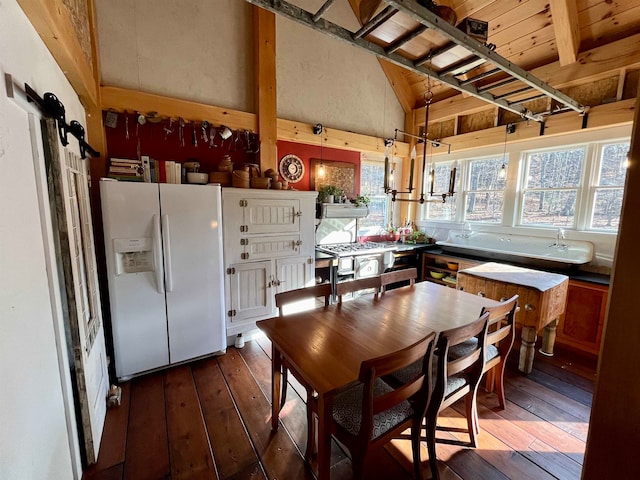 dining space featuring dark hardwood / wood-style floors and high vaulted ceiling