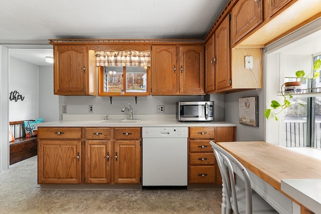 kitchen featuring white dishwasher and sink