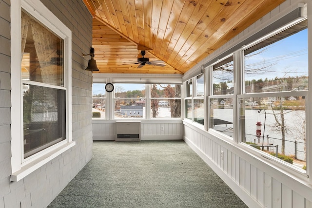 unfurnished sunroom featuring ceiling fan, wood ceiling, and lofted ceiling