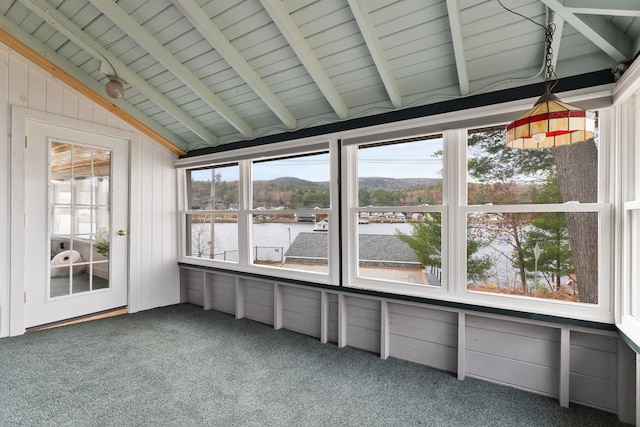 unfurnished sunroom featuring lofted ceiling with beams and a mountain view