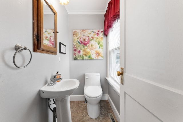 bathroom with toilet, tile patterned flooring, and ornamental molding