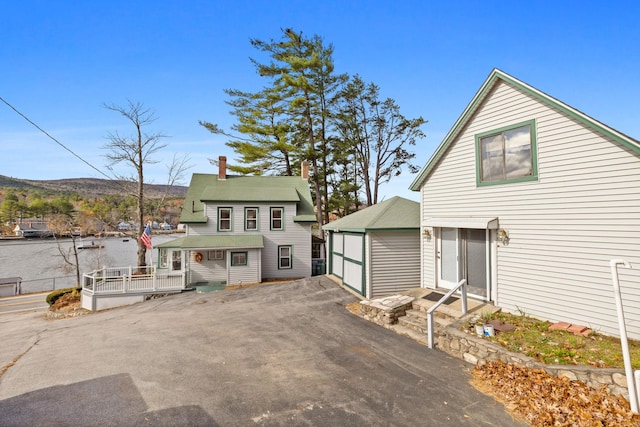 view of front property featuring a garage and an outbuilding