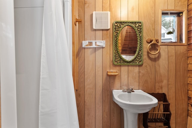 bathroom featuring wooden walls