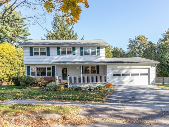 67 Case Pkwy, Burlington, VT 05401 - traditional-style house with covered porch, driveway, and an attached garage