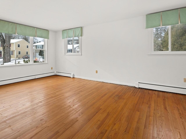 67 Case Pkwy, Burlington, VT 05401 - spare room with baseboard heating, wood finished floors, and baseboards