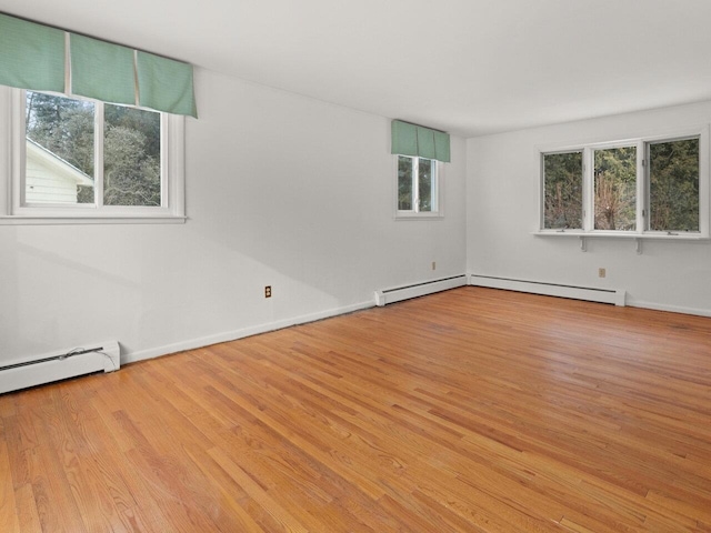 67 Case Pkwy, Burlington, VT 05401 - empty room with a baseboard radiator, wood finished floors, a baseboard heating unit, and baseboards