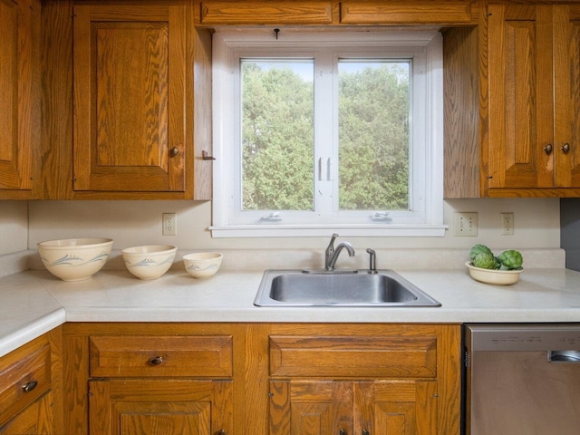 67 Case Pkwy, Burlington, VT 05401 - kitchen featuring dishwasher, a sink, light countertops, and brown cabinets